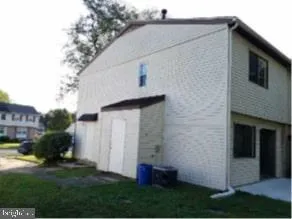 a view of backyard of house and trees