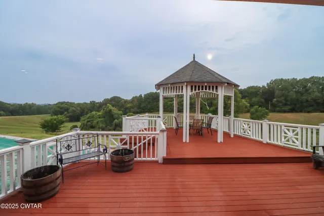 a view of a chair and tables on the roof deck