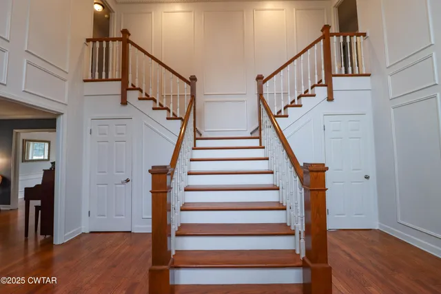 a view of entryway with wooden floor and a front door