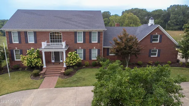 a aerial view of a house next to a yard
