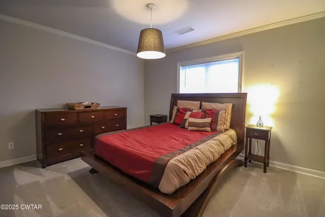 a bedroom with a bed and a chandelier