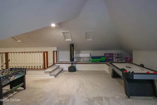 a living room with furniture and a gym