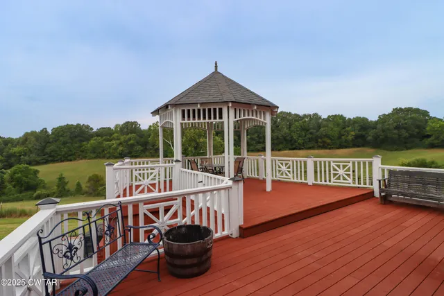 a view of a deck with two chair and wooden floor