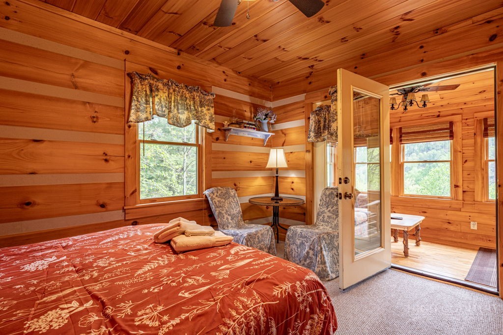 197 Woodby Ridge Road Vilas, NC 28692 - Photo 17 of 45 a bedroom with a bed and a glass door