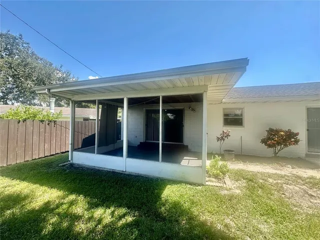 a view of a house with backyard and porch