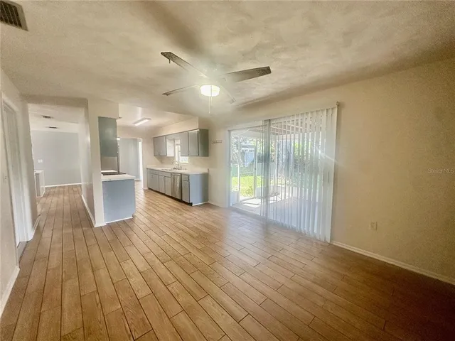 a view of a room with wooden floor and windows