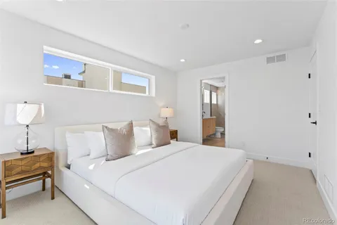 a bathroom with a granite countertop sink a toilet and shower