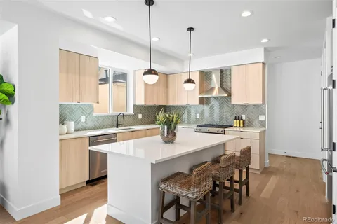 a kitchen with a sink a counter top space cabinets and stainless steel appliances