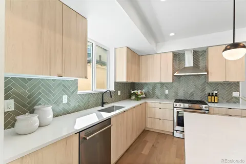a kitchen with a sink and a stove top oven