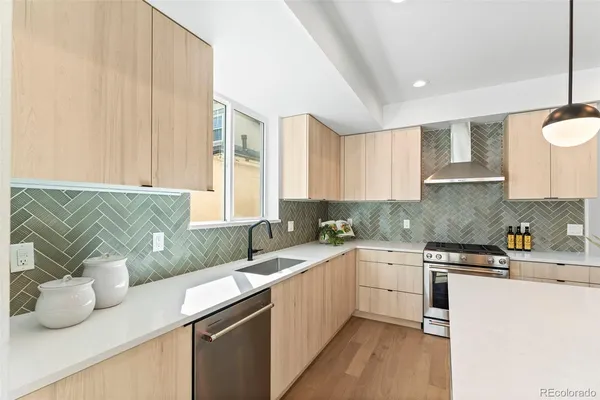 a kitchen with a sink and a stove top oven