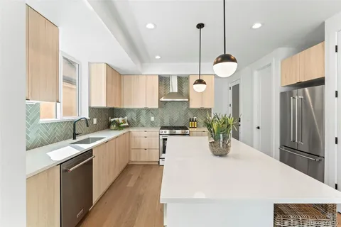a kitchen with a sink stove and cabinets