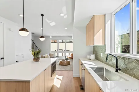 a living room with furniture fireplace and a large window