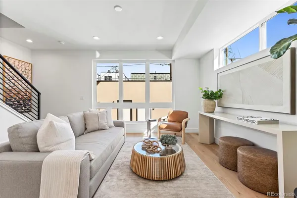 a living room with furniture a potted plant and a fireplace