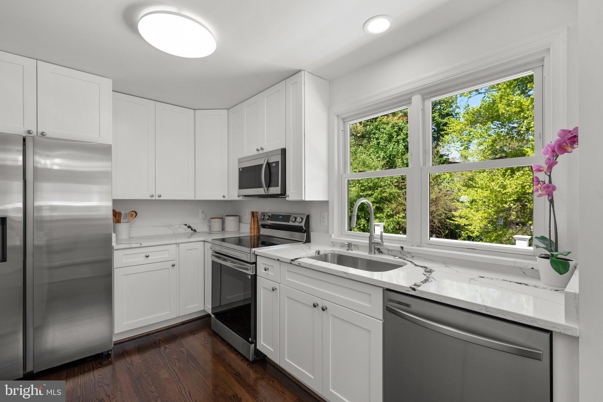 10126 Renfrew Road Silver Spring, MD 20901 - Photo 12 of 40 a kitchen with a sink appliances cabinets and a window