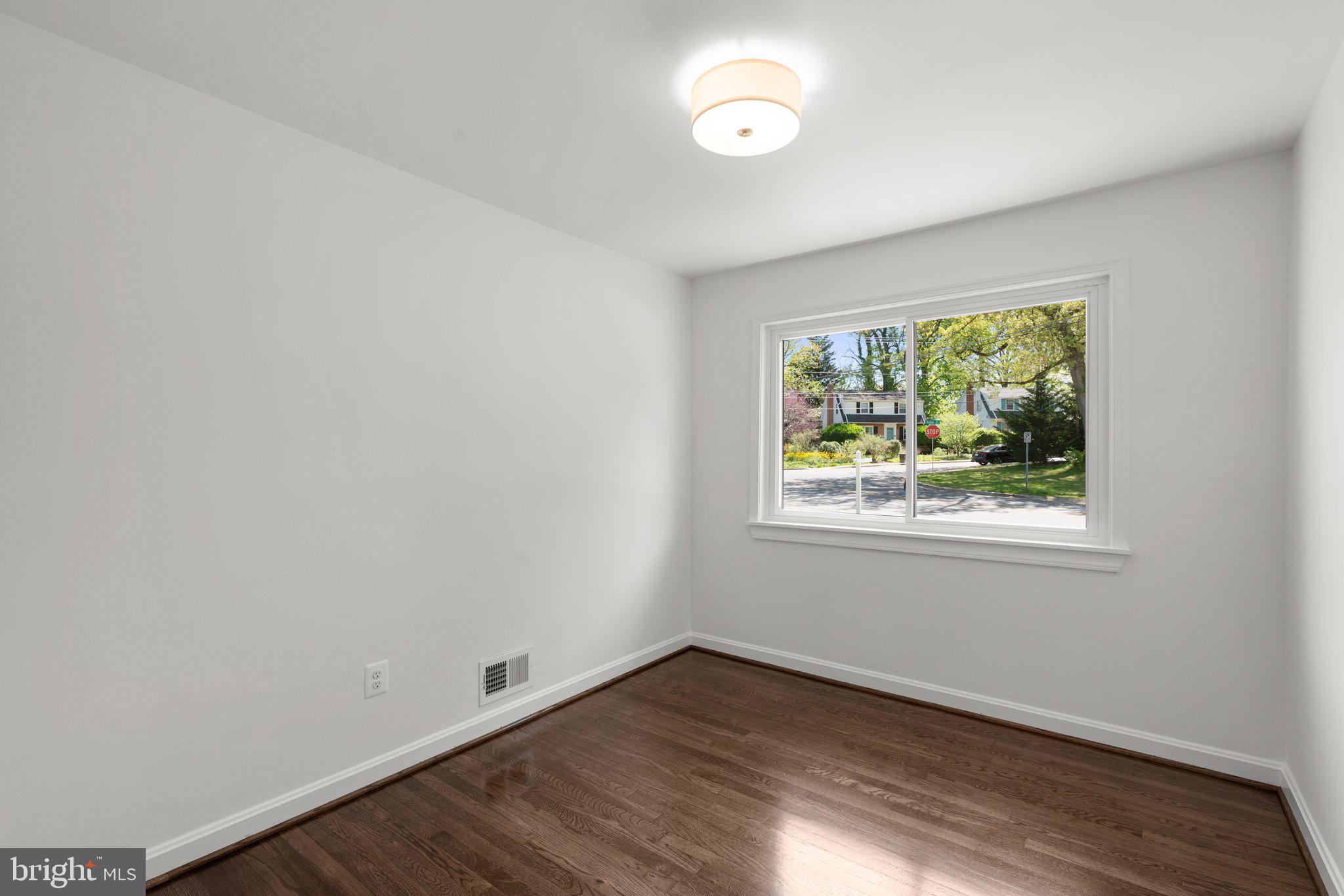 10126 Renfrew Road Silver Spring, MD 20901 - Photo 18 of 40 an empty room with wooden floor and windows