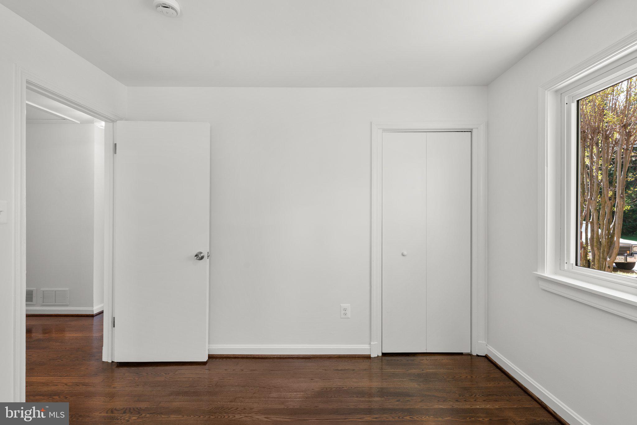 10126 Renfrew Road Silver Spring, MD 20901 - Photo 21 of 40 a view of an empty room with wooden floor and a window