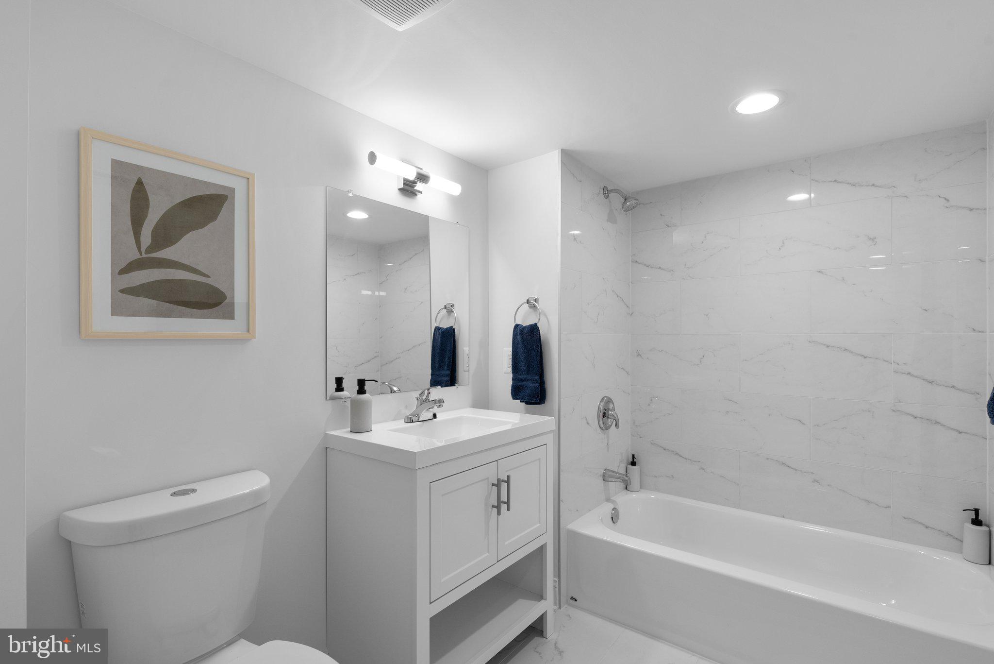 10126 Renfrew Road Silver Spring, MD 20901 - Photo 31 of 40 a bathroom with a double vanity sink toilet and bathtub