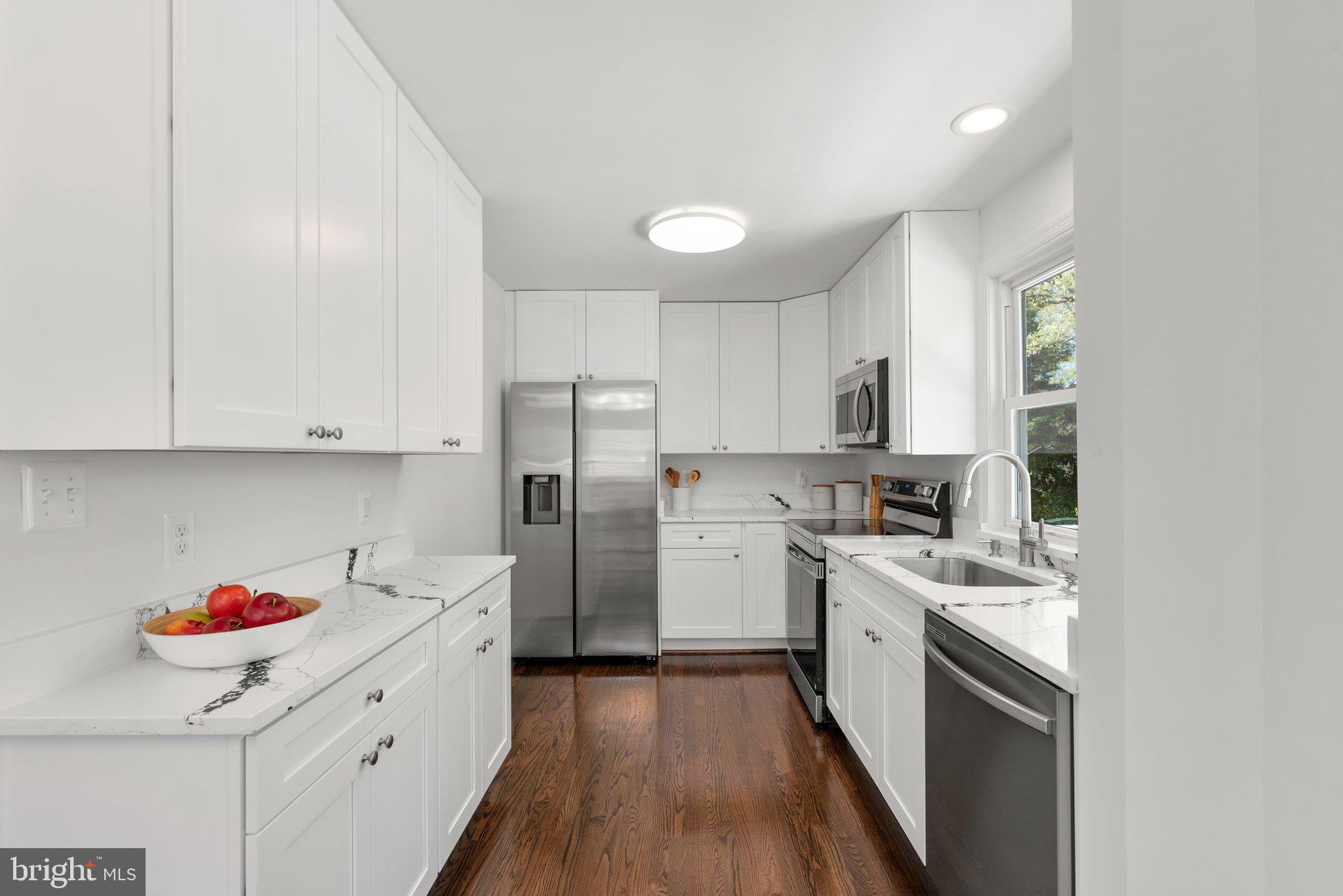 10126 Renfrew Road Silver Spring, MD 20901 - Photo 4 of 40 a kitchen with a sink cabinets stainless steel appliances and a window
