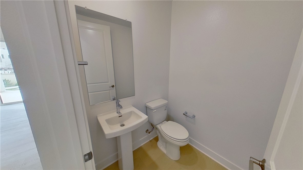 106 Yugen Irvine, CA 92618 - Photo 11 of 28 a white toilet sitting next to a small sink