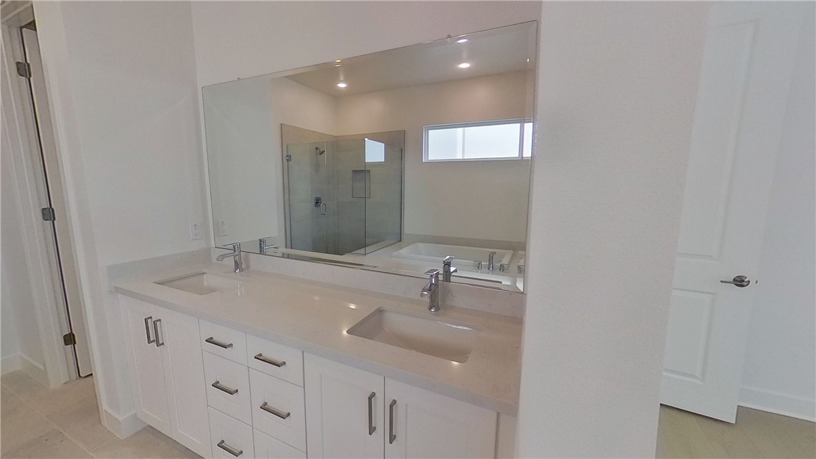 106 Yugen Irvine, CA 92618 - Photo 20 of 28 a bathroom with a sink double vanity and mirror