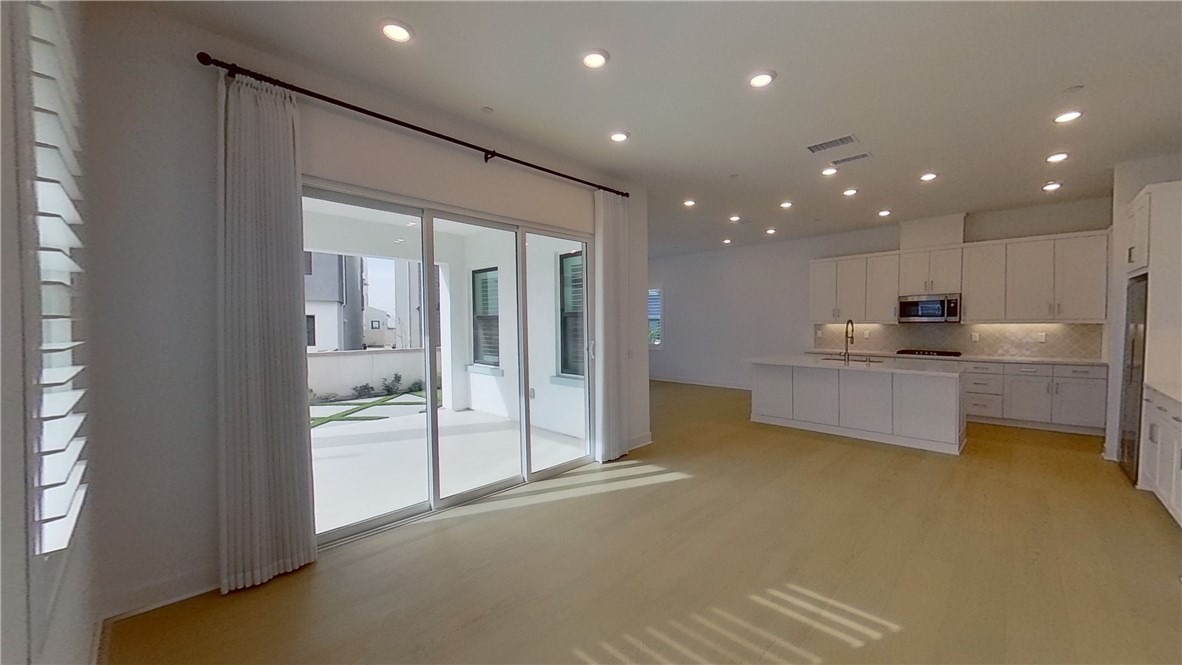 106 Yugen Irvine, CA 92618 - Photo 2 of 28 a view of a kitchen with a sink and a refrigerator