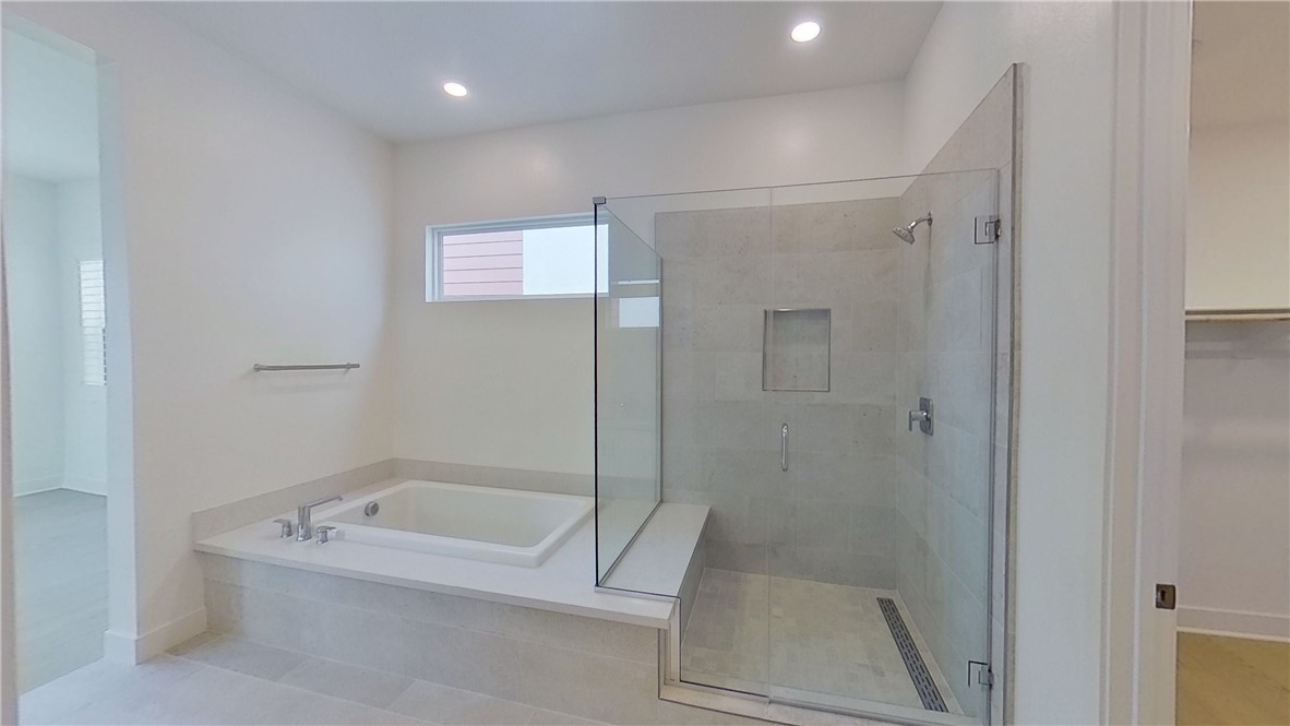 106 Yugen Irvine, CA 92618 - Photo 22 of 28 a bathroom with a tub a toilet and a shower