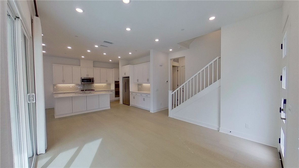 106 Yugen Irvine, CA 92618 - Photo 3 of 28 a view of kitchen with kitchen island white cabinets and stainless steel appliances