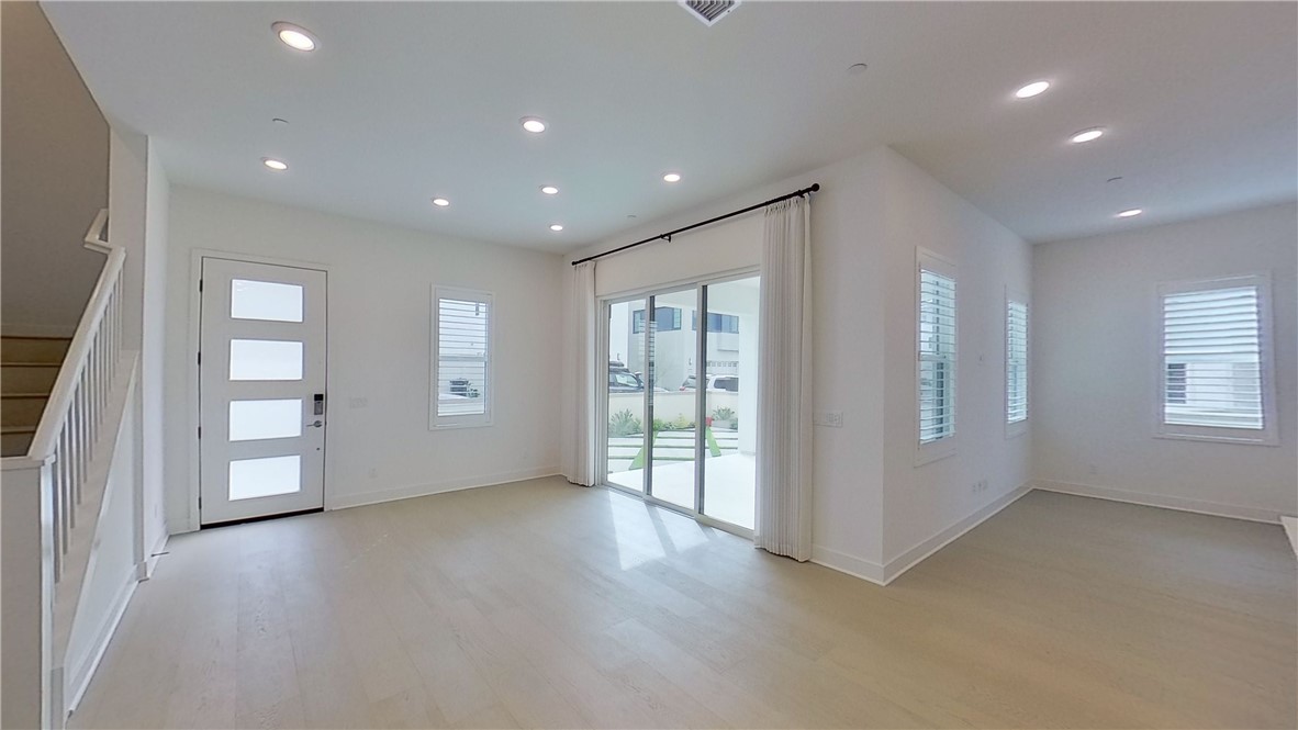 106 Yugen Irvine, CA 92618 - Photo 6 of 28 an empty room with windows and pillars in it