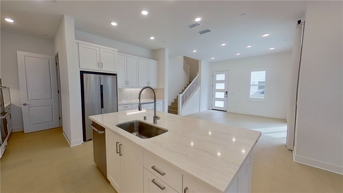 106 Yugen Irvine, CA 92618 - Photo 8 of 28 a kitchen with a sink and refrigerator