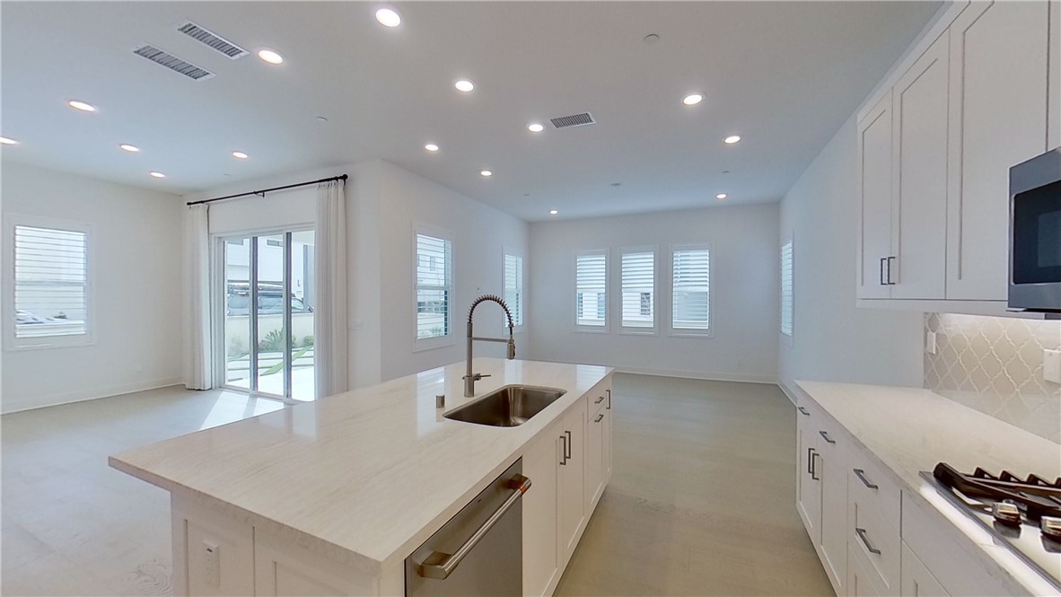 106 Yugen Irvine, CA 92618 - Photo 10 of 28 a kitchen with a sink a stove and cabinets