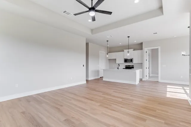 a view of a kitchen with a sink and a refrigerator