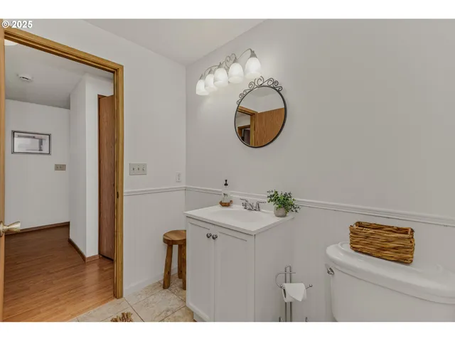 a bathroom with a sink mirror and toilet