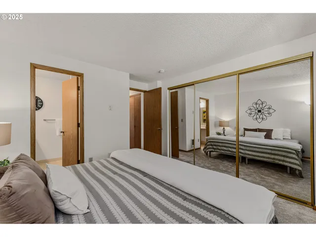 a bedroom with a bed and a lamp