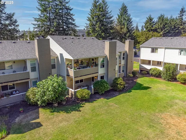 an aerial view of a house with a yard basket ball court and outdoor seating