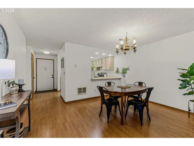 a bathroom with a sink a mirror and a potted plant