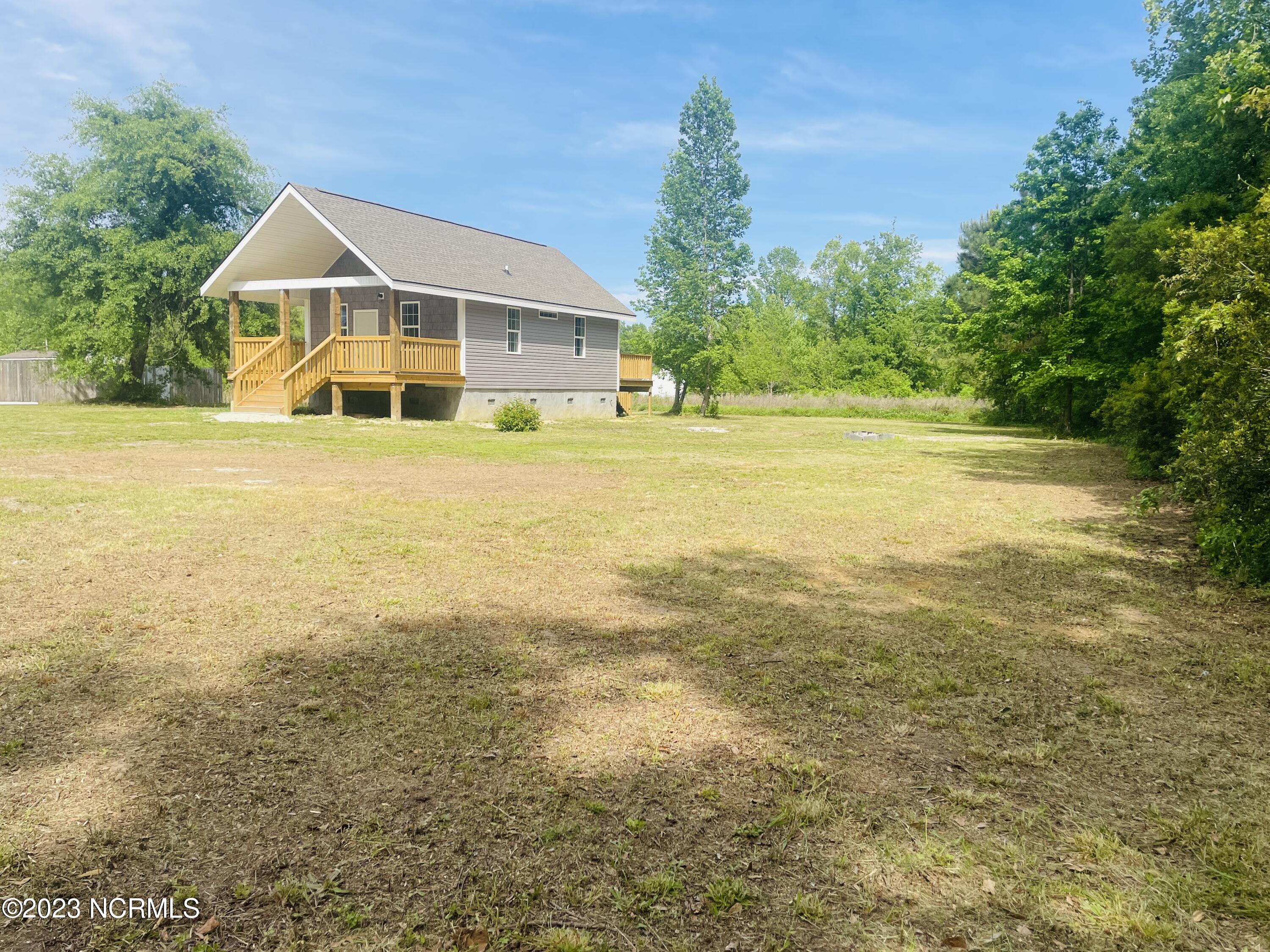 213 Sanders Street Tabor City, NC 28463 - Photo 23 of 25 Build a fire pit, enjoy smores and catching fireflies in this backyard.