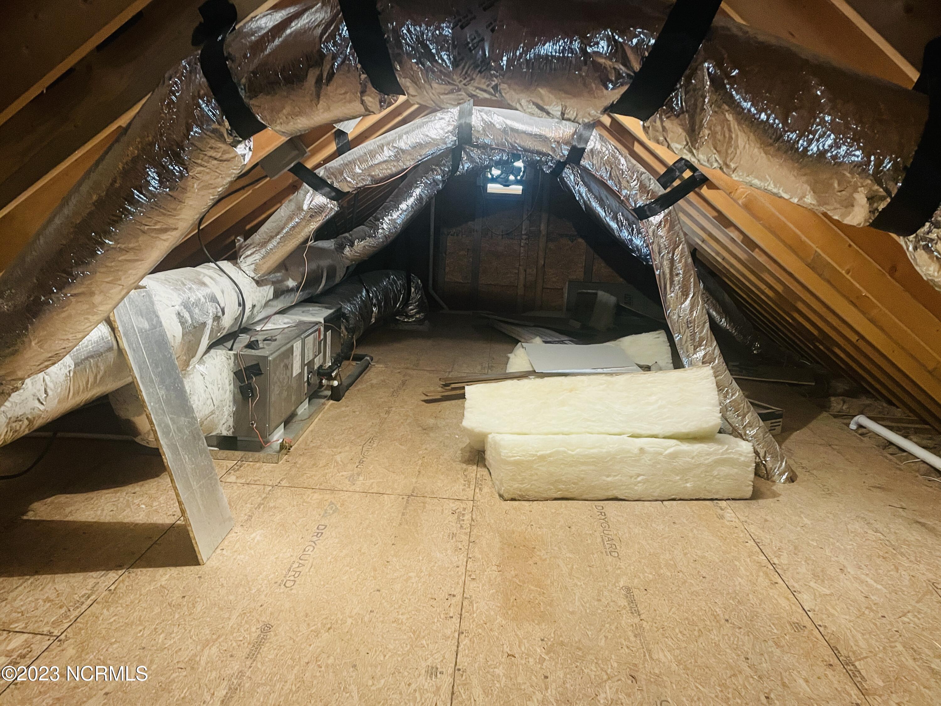 213 Sanders Street Tabor City, NC 28463 - Photo 24 of 25 This vented and floor attic space is ready for all of your seasonal decor and offers tons of storage options.