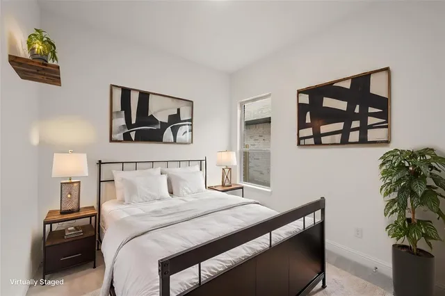 a bedroom with a bed and a painting on the wall