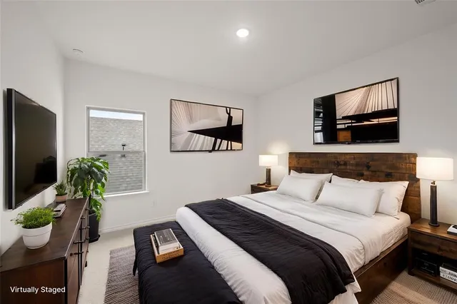 a bedroom with a bed and a potted plant