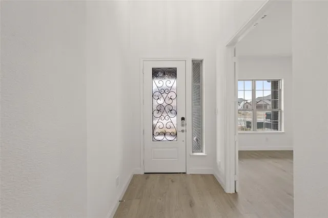 a view of an entryway with wooden floor