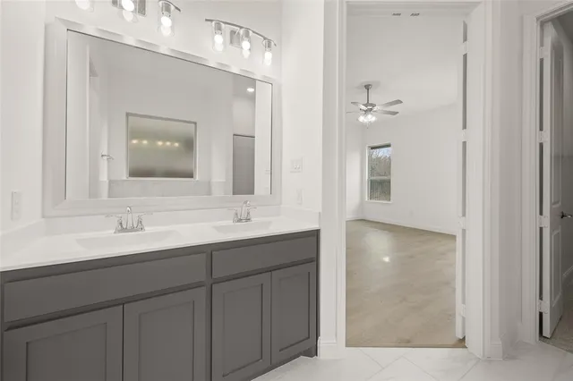 a bathroom with a double vanity sink and a mirror