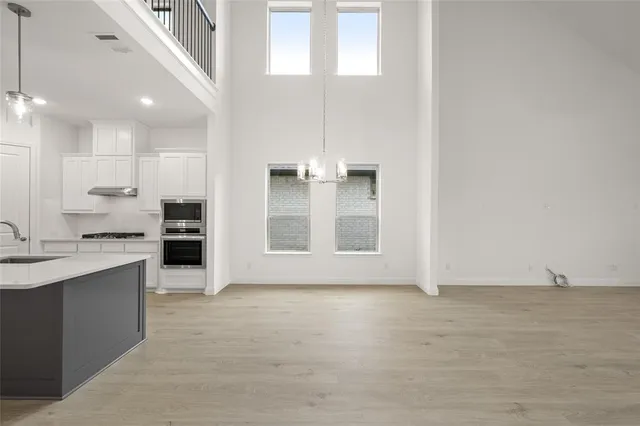 a view of kitchen with granite countertop cabinets and sink