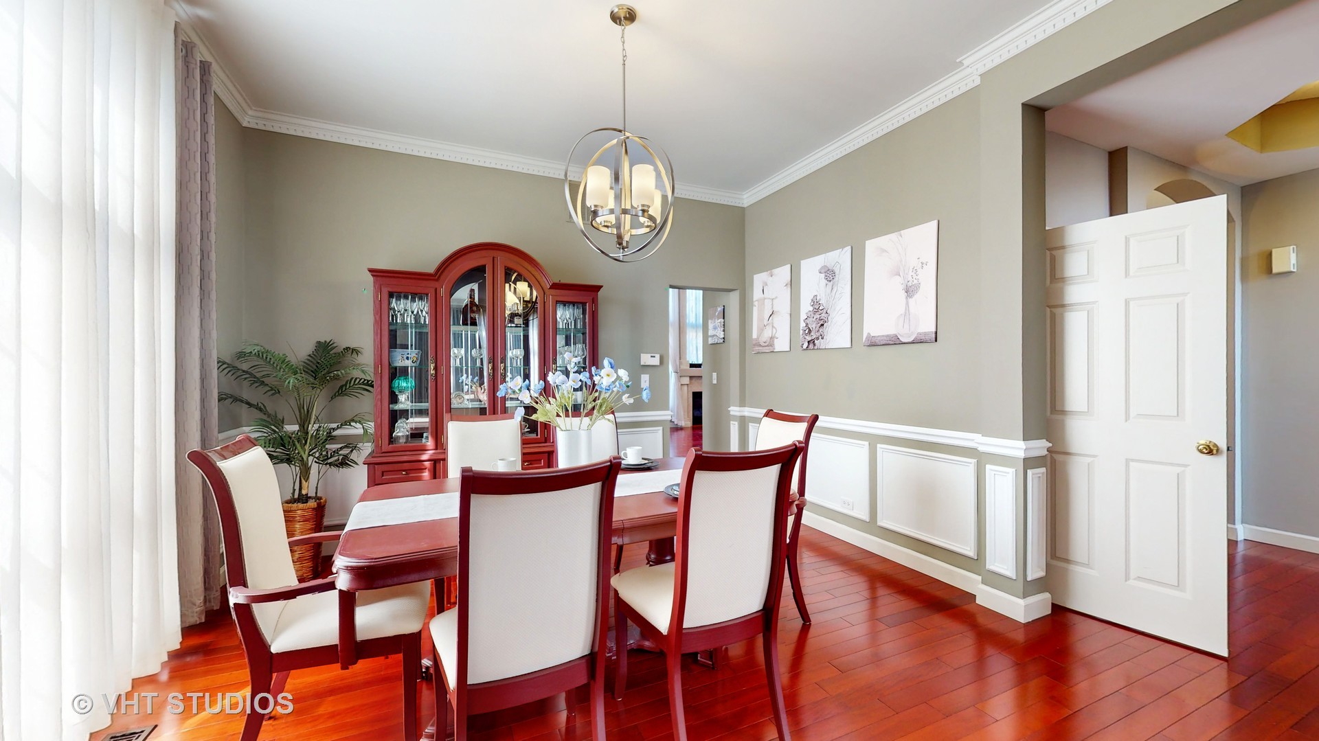 811 Commons Road Naperville, IL 60563 - Photo 11 of 61 a view of a dining room with furniture wooden floor and chandelier