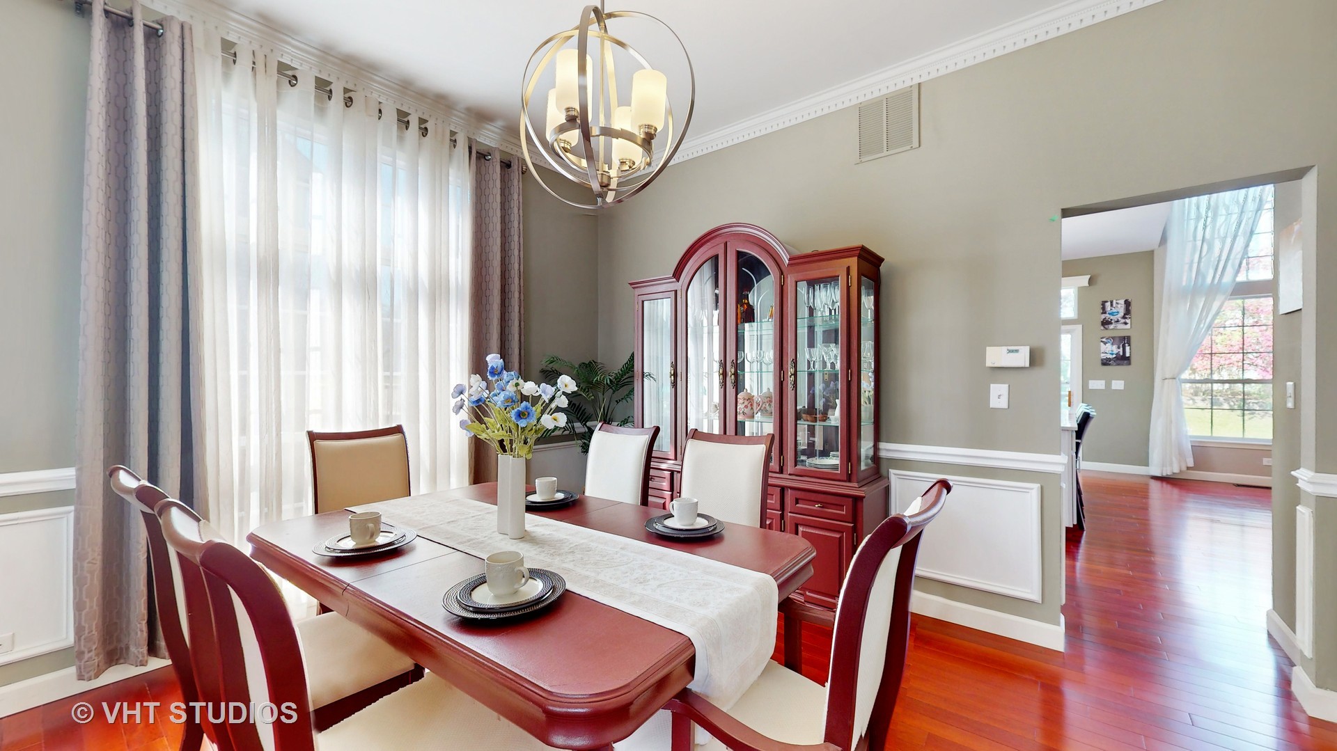 811 Commons Road Naperville, IL 60563 - Photo 12 of 61 a dining room with furniture a chandelier and wooden floor