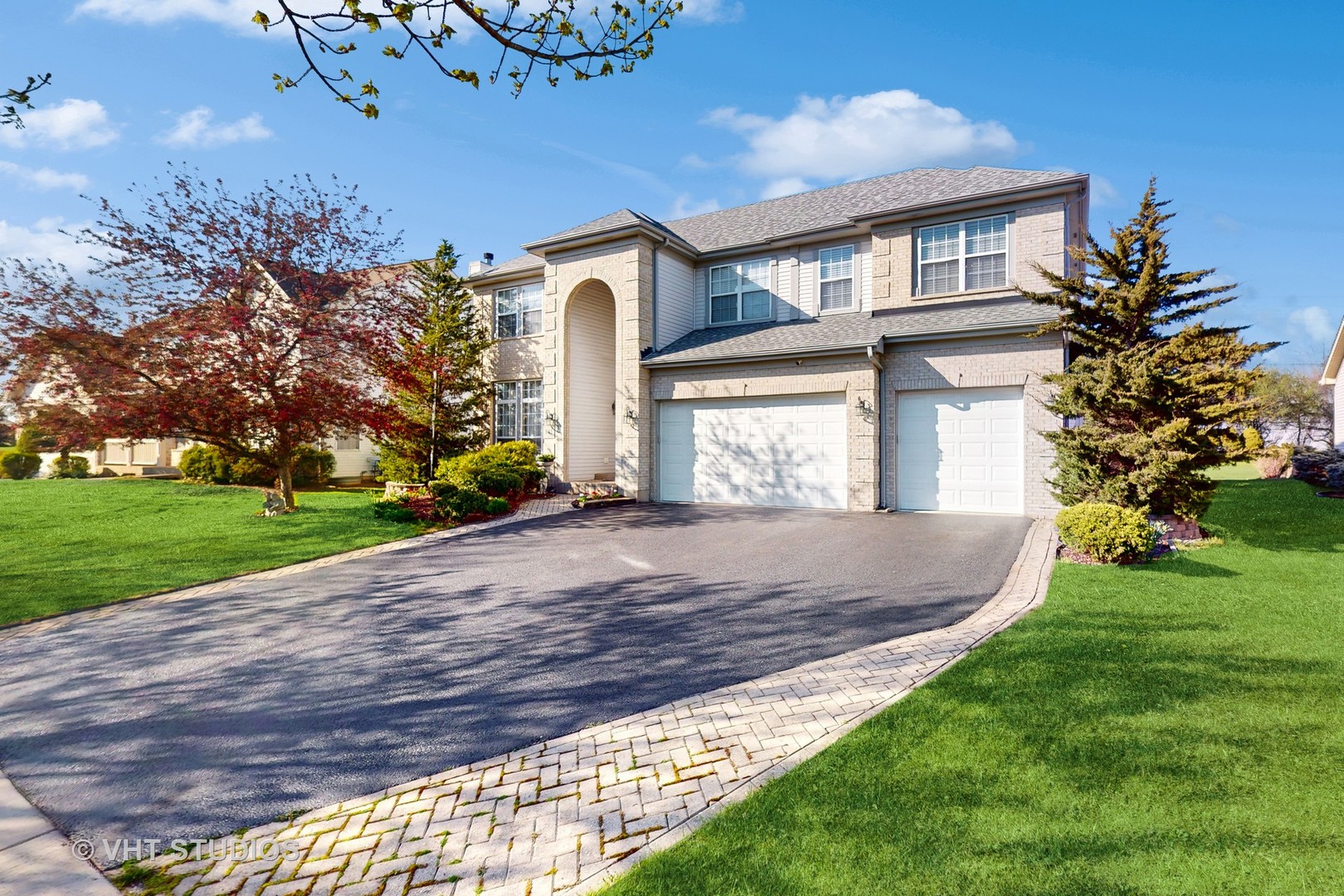811 Commons Road Naperville, IL 60563 - Photo 3 of 61 a front view of a house with a yard and a garage