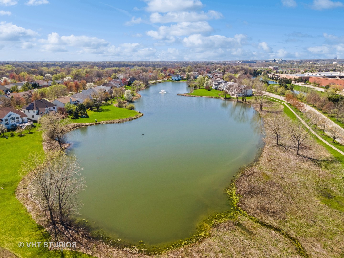 811 Commons Road Naperville, IL 60563 - Photo 57 of 61 a view of a lake with a yard