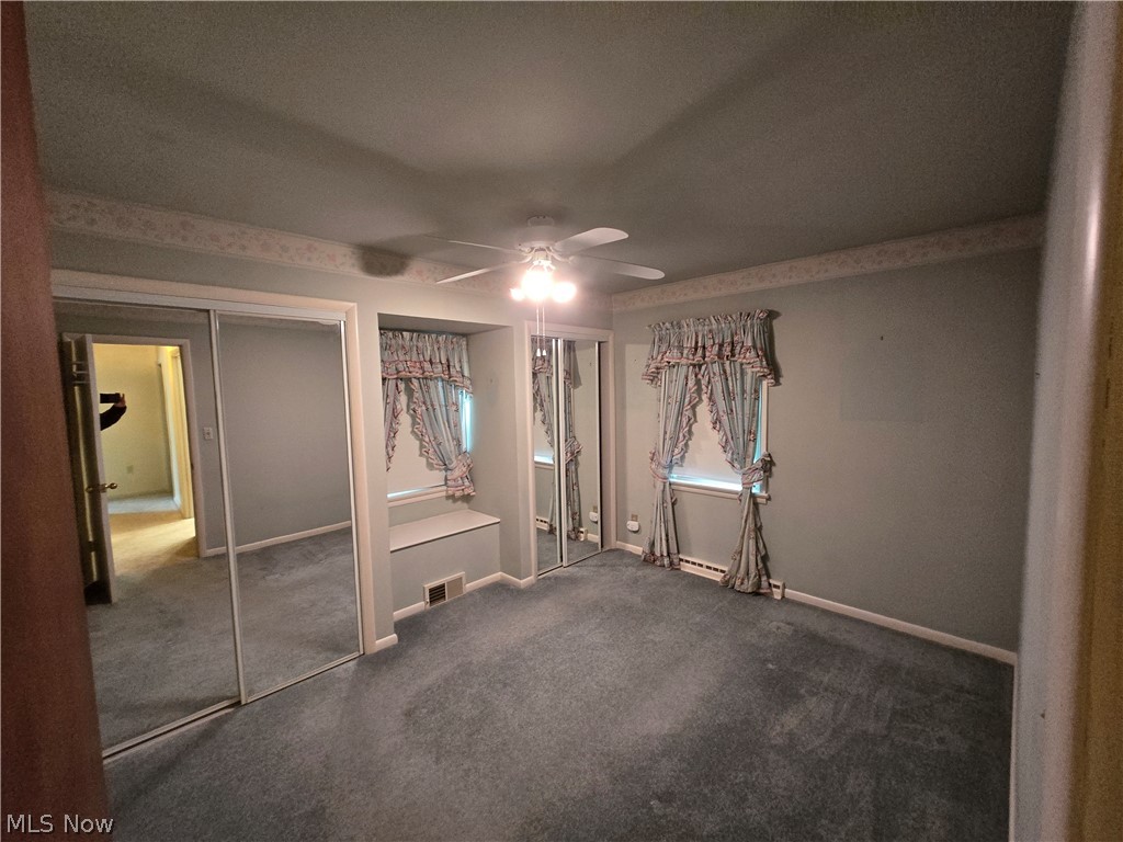 2550 Merria Road Stow, OH 44224 - Photo 18 of 22 Unfurnished bedroom featuring ceiling fan, baseboard heating, and dark carpet
