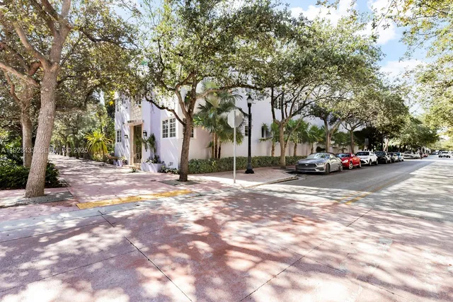 a view of road with parked cars