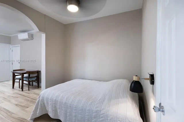 a bedroom with a bed and a table in it