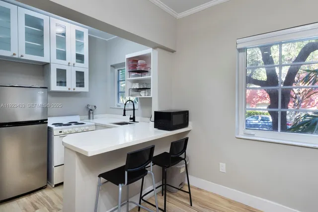 a view of a dining room with furniture a rug and wooden floor